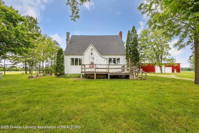 16544 S Chapin Rd, Elsie, MI 48831 - back of house featuring a deck, a yard, an outbuilding, and a shingled roof