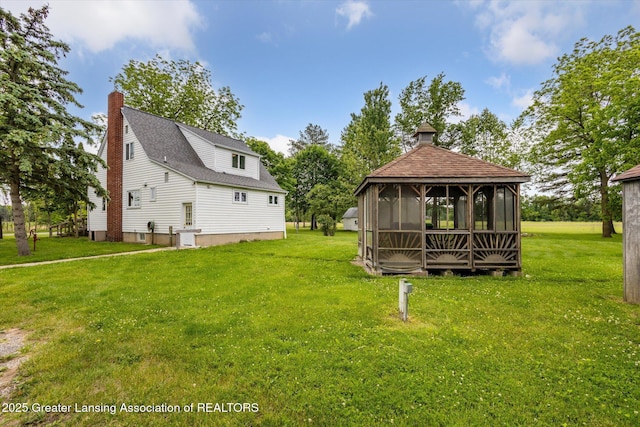 16544 S Chapin Rd, Elsie, MI 48831 - rear view of house featuring a gazebo, a lawn, a chimney, and roof with shingles