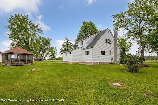 16544 S Chapin Rd, Elsie, MI 48831 - view of side of property featuring a gazebo, a chimney, and a lawn