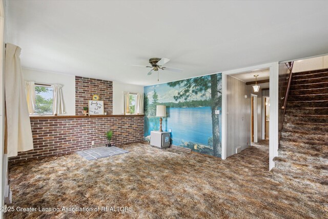 16544 S Chapin Rd, Elsie, MI 48831 - unfurnished living room with carpet floors, ceiling fan, and stairs