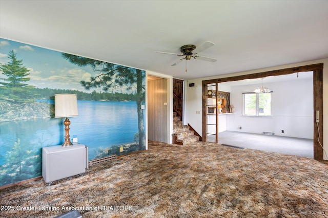 16544 S Chapin Rd, Elsie, MI 48831 - unfurnished living room with ceiling fan, stairway, and carpet