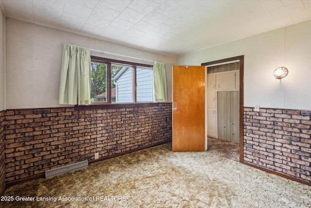 16544 S Chapin Rd, Elsie, MI 48831 - unfurnished bedroom featuring carpet floors and brick wall