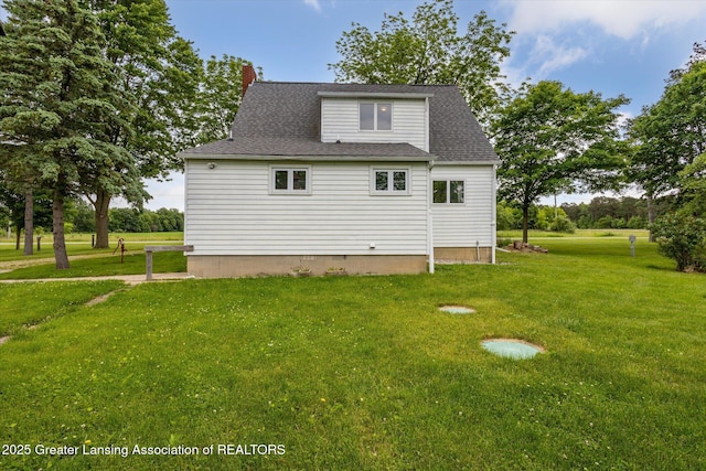 16544 S Chapin Rd, Elsie, MI 48831 - back of house featuring a lawn, a chimney, and roof with shingles