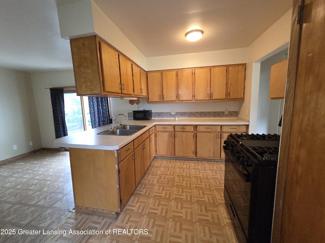 3629 Alpine Dr, Lansing, MI 48911 - kitchen with black appliances, light countertops, a peninsula, brown cabinetry, and light flooring
