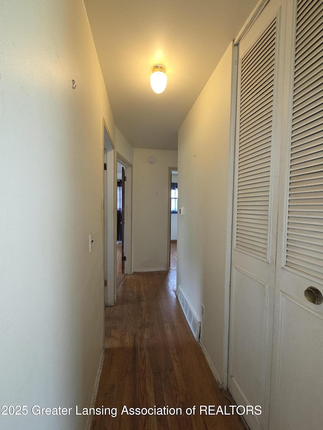 3629 Alpine Dr, Lansing, MI 48911 - hall featuring dark wood-type flooring and baseboards