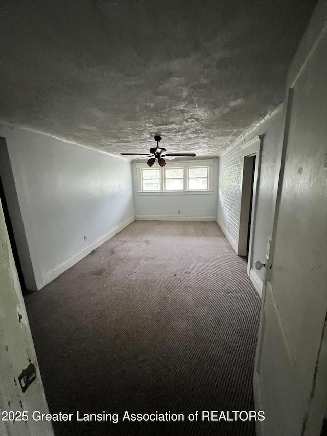 909 Baker St, Lansing, MI 48910 - carpeted empty room with a ceiling fan and baseboards