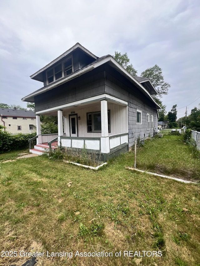 909 Baker St, Lansing, MI 48910 - view of front facade with covered porch and a front lawn
