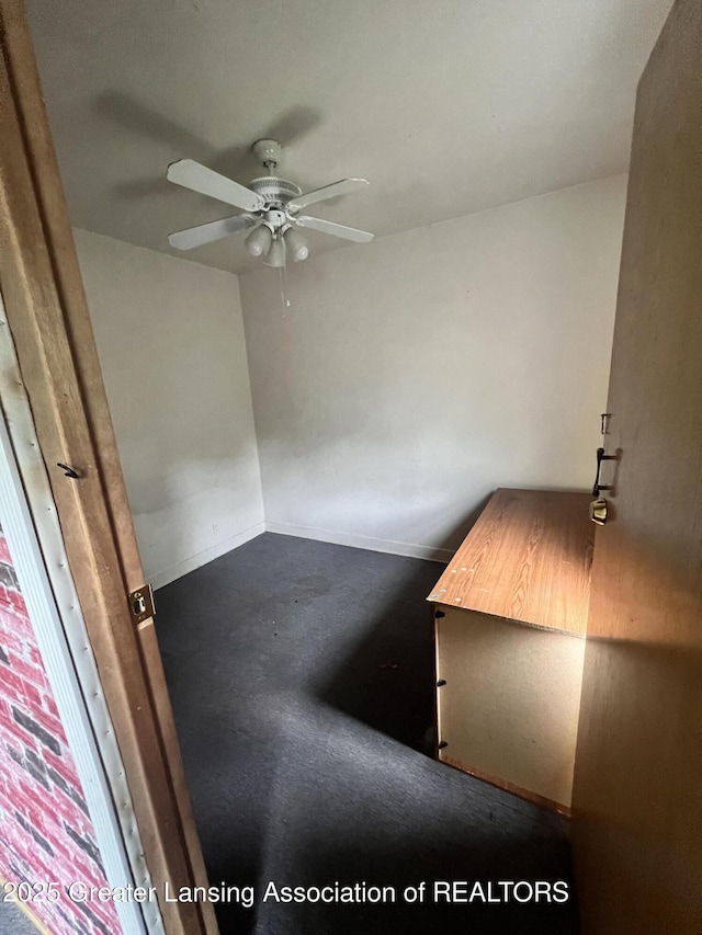 909 Baker St, Lansing, MI 48910 - unfurnished bedroom with baseboards and a ceiling fan