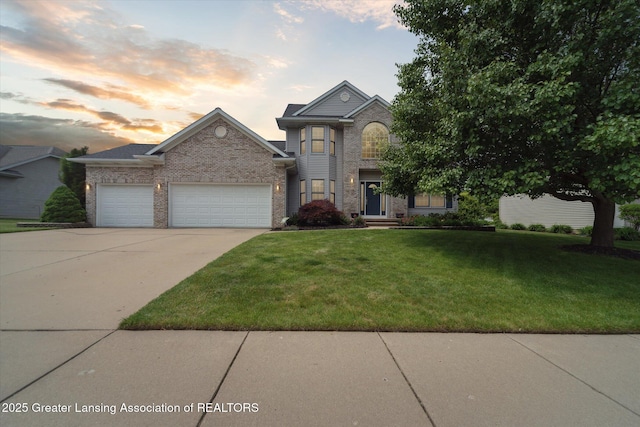 11195 Prestwick Dr, Lansing, MI 48917 - traditional-style home with a garage, concrete driveway, a yard, and brick siding