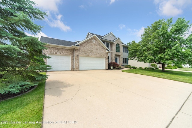 11195 Prestwick Dr, Lansing, MI 48917 - view of front of home featuring concrete driveway, a garage, a front yard, brick siding, and roof with shingles