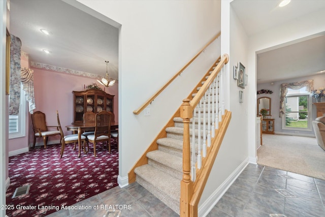 11195 Prestwick Dr, Lansing, MI 48917 - stairway with carpet and a chandelier