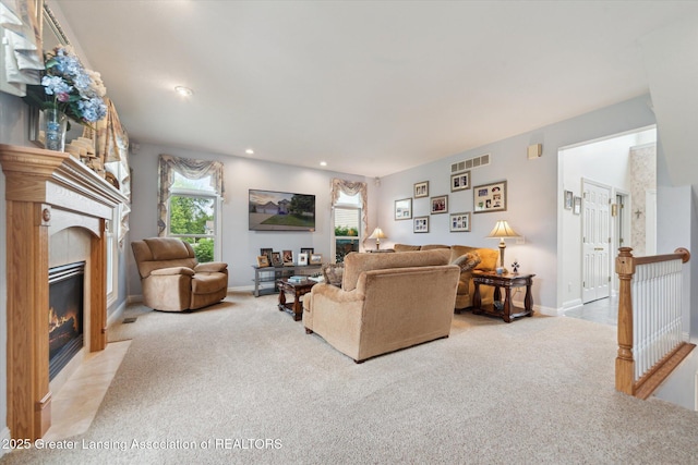 11195 Prestwick Dr, Lansing, MI 48917 - living area featuring carpet flooring, a fireplace with flush hearth, and recessed lighting