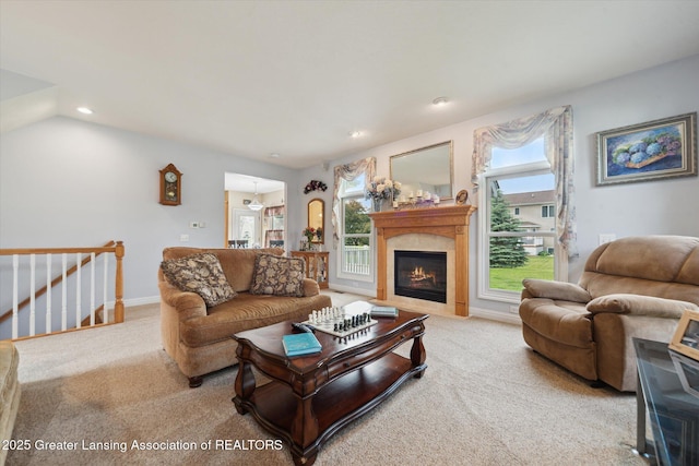 11195 Prestwick Dr, Lansing, MI 48917 - living area with light colored carpet, a glass covered fireplace, and recessed lighting