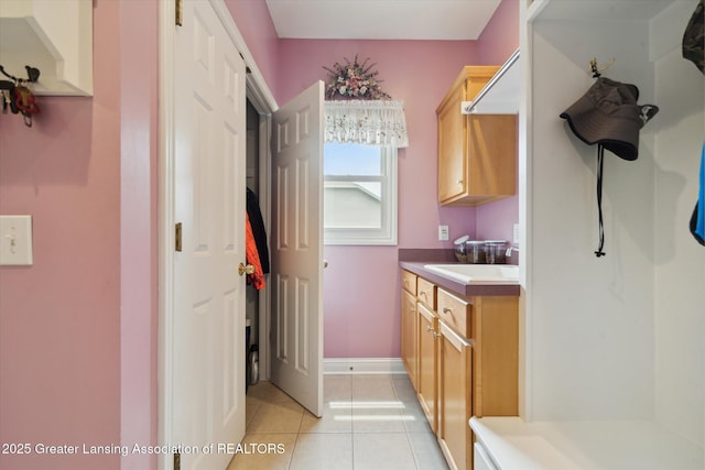 11195 Prestwick Dr, Lansing, MI 48917 - laundry room with light tile patterned floors and a sink
