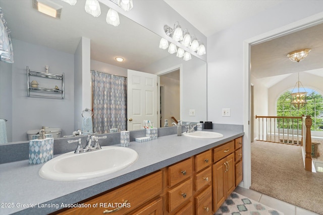 11195 Prestwick Dr, Lansing, MI 48917 - full bathroom with double vanity, tile patterned flooring, and a chandelier