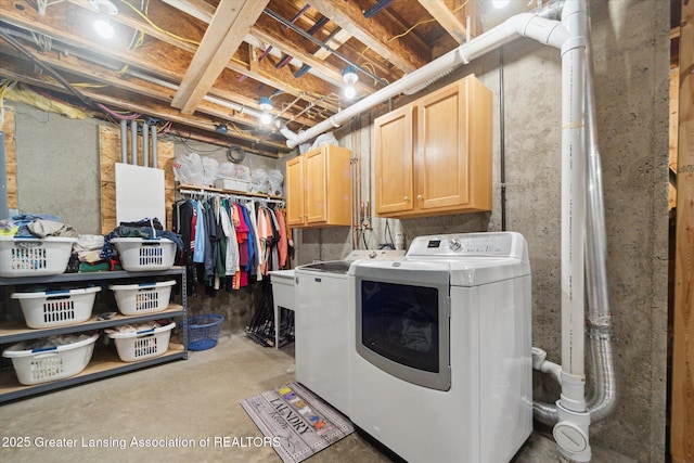 11195 Prestwick Dr, Lansing, MI 48917 - washroom featuring washing machine and dryer and cabinet space
