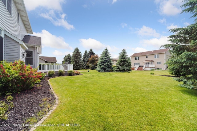 11195 Prestwick Dr, Lansing, MI 48917 - view of grassy yard featuring a wooden deck