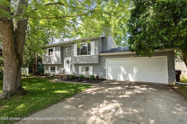 1539 Jacqueline Dr, Holt, MI 48842 - raised ranch featuring driveway, a garage, a front yard, and a chimney