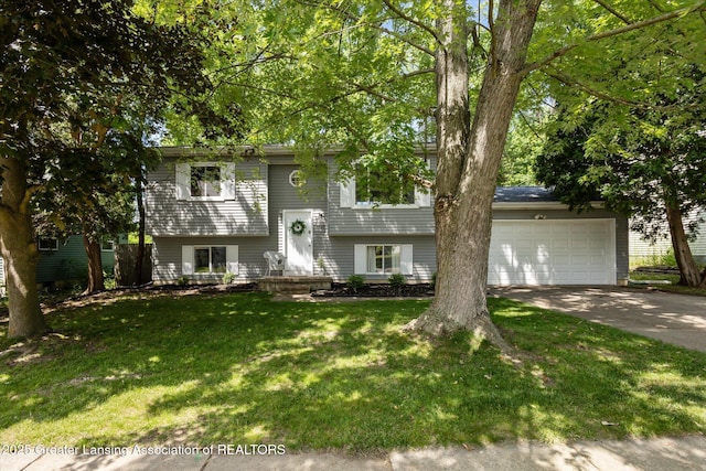 1539 Jacqueline Dr, Holt, MI 48842 - bi-level home featuring a garage, concrete driveway, and a front lawn