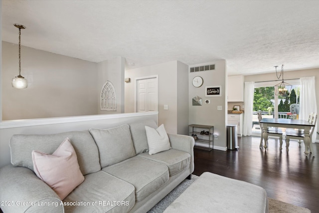 1539 Jacqueline Dr, Holt, MI 48842 - living area with dark wood-style flooring and a chandelier