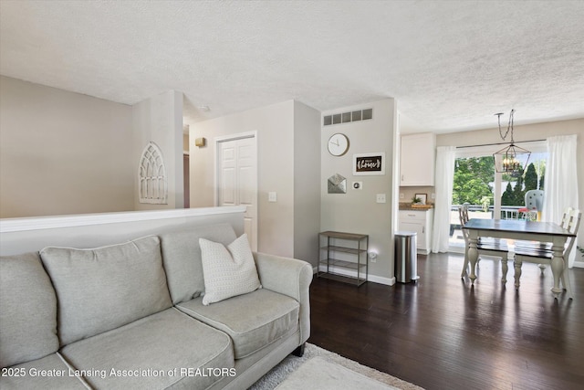1539 Jacqueline Dr, Holt, MI 48842 - living area featuring dark wood-style floors and a textured ceiling
