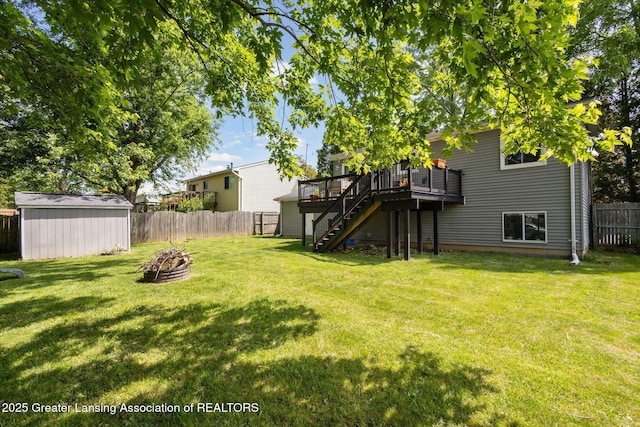 1539 Jacqueline Dr, Holt, MI 48842 - fenced backyard with an outdoor fire pit, stairway, a wooden deck, and a shed