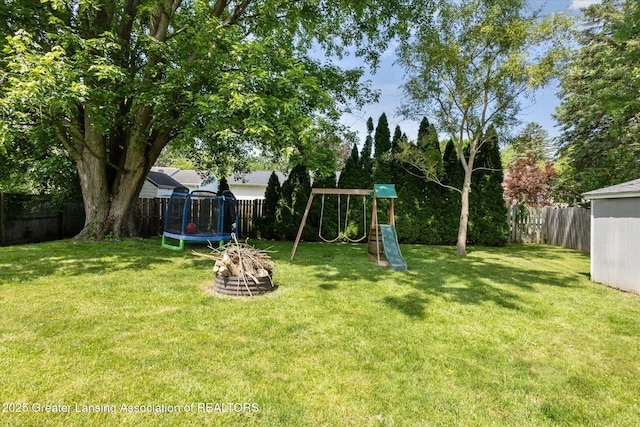1539 Jacqueline Dr, Holt, MI 48842 - fenced backyard featuring a trampoline and a playground