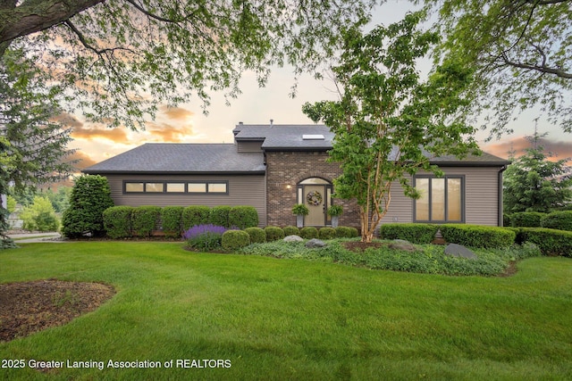 4925 Aspen Dr, Lansing, MI 48917 - view of front of house with a front lawn and roof with shingles
