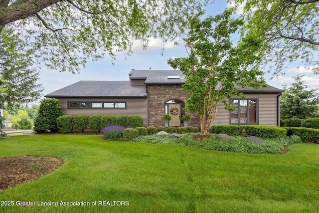 4925 Aspen Dr, Lansing, MI 48917 - view of front of home with a front yard and roof with shingles