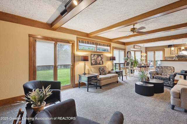 4925 Aspen Dr, Lansing, MI 48917 - carpeted living room featuring beamed ceiling, a textured wall, a ceiling fan, and a textured ceiling