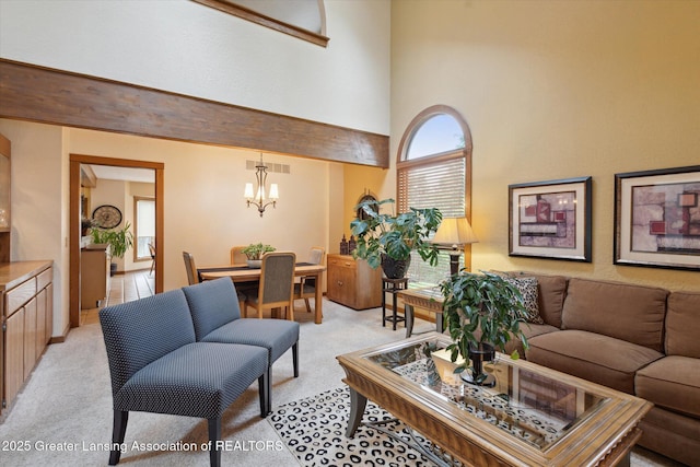 4925 Aspen Dr, Lansing, MI 48917 - living room with light carpet, a chandelier, and a towering ceiling