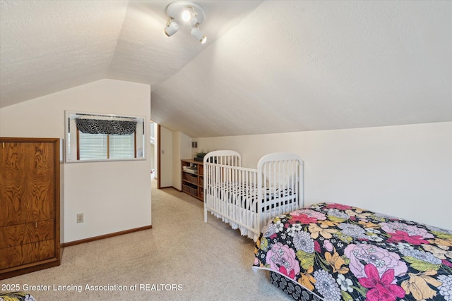 4925 Aspen Dr, Lansing, MI 48917 - bedroom with lofted ceiling, light colored carpet, and a textured ceiling