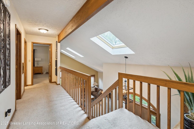 4925 Aspen Dr, Lansing, MI 48917 - corridor with a skylight, a textured ceiling, carpet, beam ceiling, and an upstairs landing