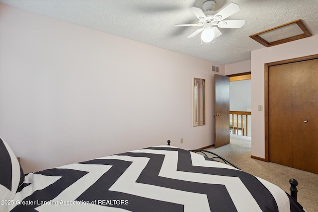 4925 Aspen Dr, Lansing, MI 48917 - unfurnished bedroom featuring attic access, a textured ceiling, light carpet, a closet, and ceiling fan