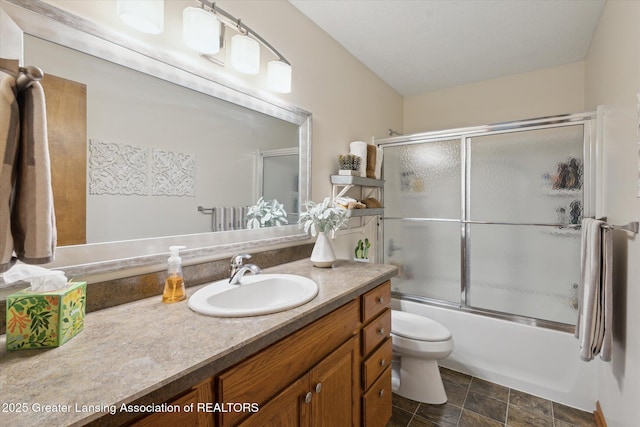 4925 Aspen Dr, Lansing, MI 48917 - full bath with vanity, shower / bath combination with glass door, and stone finish flooring
