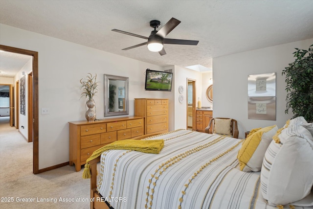 4925 Aspen Dr, Lansing, MI 48917 - bedroom with light carpet, a textured ceiling, a ceiling fan, and ensuite bath