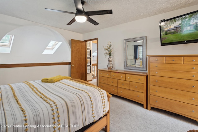 4925 Aspen Dr, Lansing, MI 48917 - bedroom with a skylight, light carpet, a textured ceiling, and ceiling fan