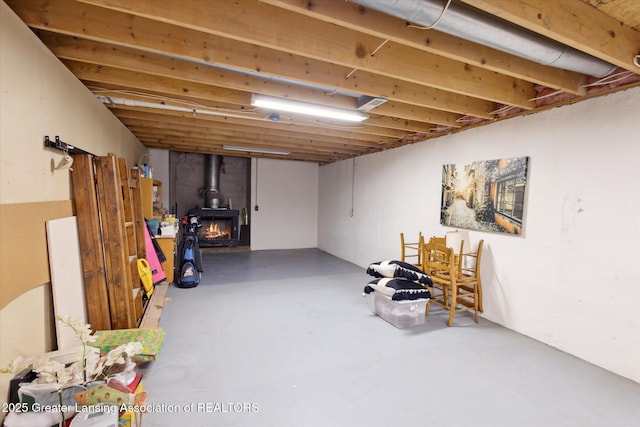 4925 Aspen Dr, Lansing, MI 48917 - below grade area with a wood stove