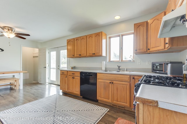 2520 Linn Rd, Williamston, MI 48895 - kitchen with black dishwasher, exhaust hood, light countertops, dark wood-style floors, and recessed lighting