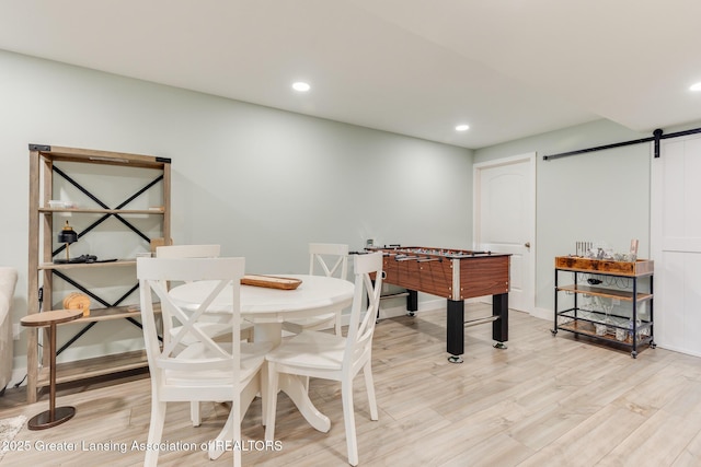 2520 Linn Rd, Williamston, MI 48895 - recreation room featuring a barn door, light wood-style floors, and recessed lighting