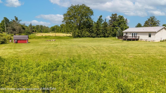 2520 Linn Rd, Williamston, MI 48895 - view of grassy yard with a deck and a storage shed