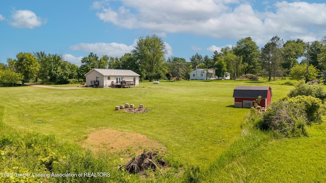 2520 Linn Rd, Williamston, MI 48895 - view of green lawn with view of wooded area and a storage shed
