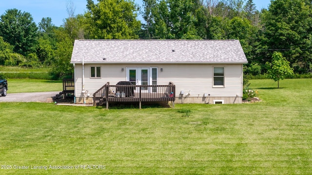 2520 Linn Rd, Williamston, MI 48895 - rear view of house featuring french doors, a deck, and a lawn