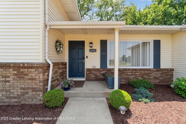 6252 N River Hwy, Grand Ledge, MI 48837 - entrance to property featuring brick siding and covered porch