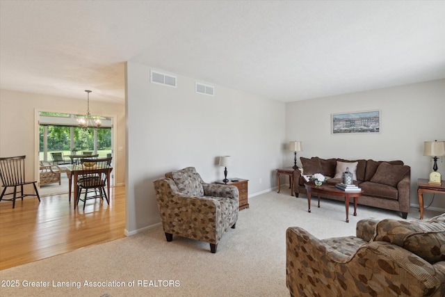 6252 N River Hwy, Grand Ledge, MI 48837 - carpeted living room with a chandelier and baseboards