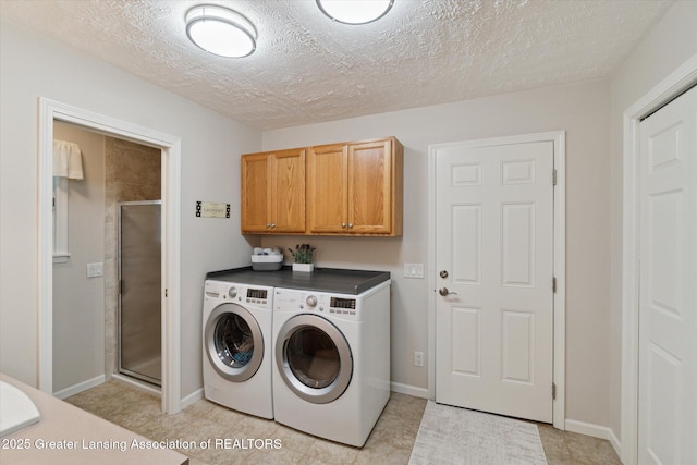6252 N River Hwy, Grand Ledge, MI 48837 - laundry area featuring washer and dryer, cabinet space, and a textured ceiling