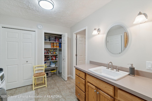 6252 N River Hwy, Grand Ledge, MI 48837 - bathroom with a closet, vanity, a textured ceiling, and tile patterned floors