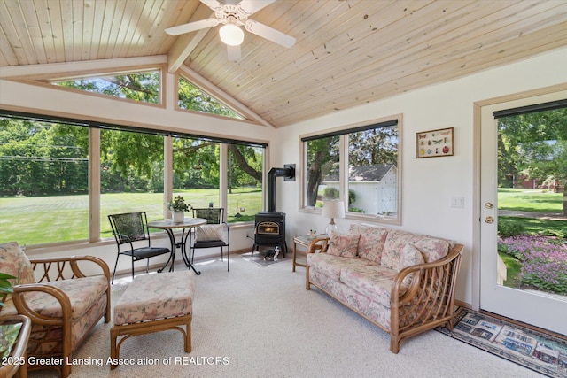 6252 N River Hwy, Grand Ledge, MI 48837 - living area featuring a wood stove, healthy amount of natural light, ceiling fan, carpet, and wood ceiling