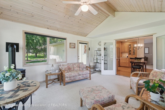 6252 N River Hwy, Grand Ledge, MI 48837 - living area with a wood stove, light colored carpet, a ceiling fan, wood ceiling, and a chandelier