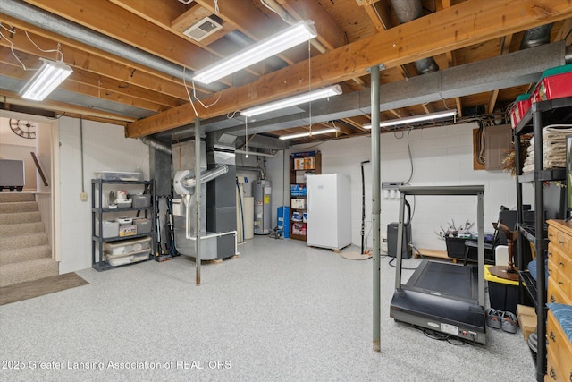 6252 N River Hwy, Grand Ledge, MI 48837 - unfinished below grade area with water heater, stairway, heating unit, and concrete block wall
